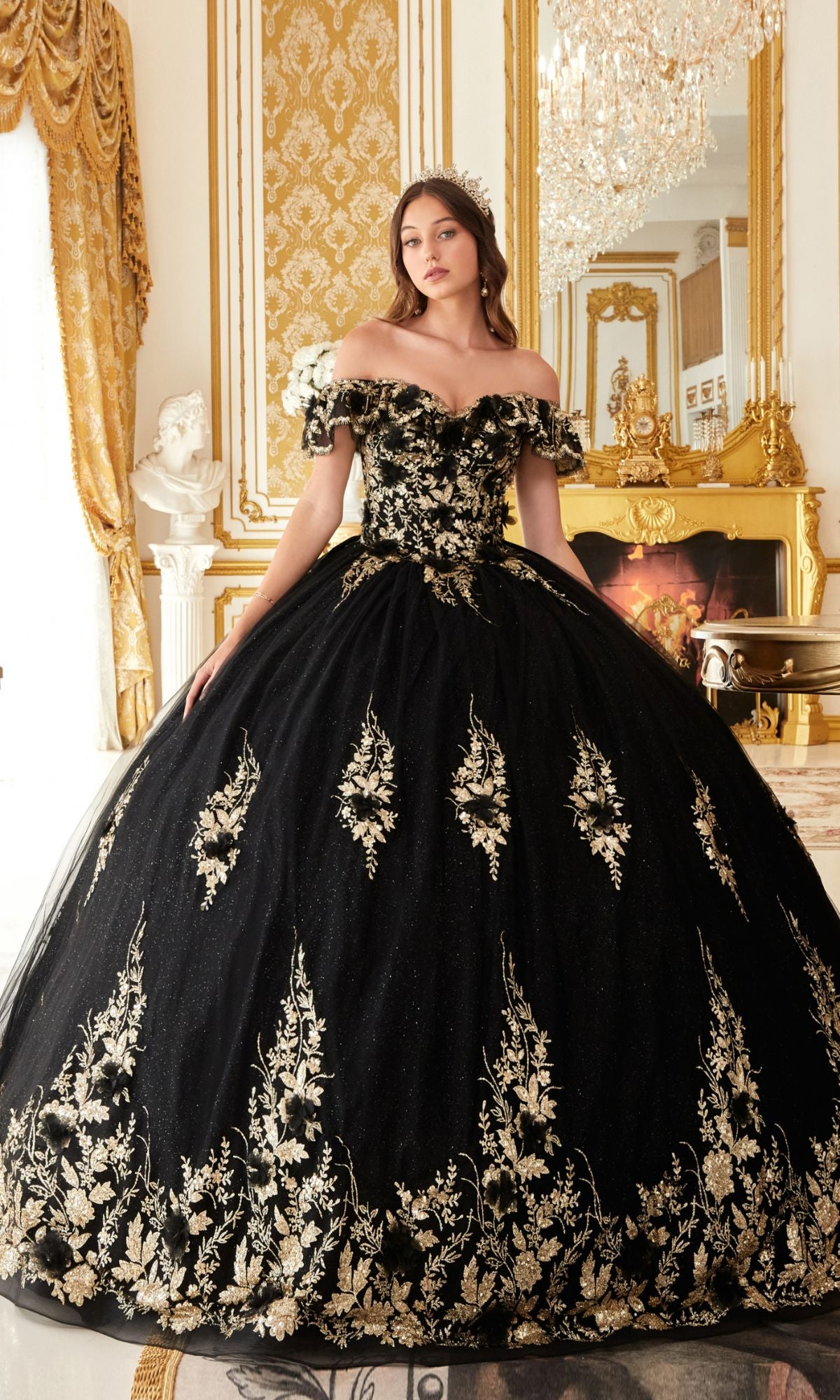 Wearing the Ladivine 15701 Glitter Quince Dress with a back bow, a woman stands in an opulent room adorned with gold decor and a chandelier.